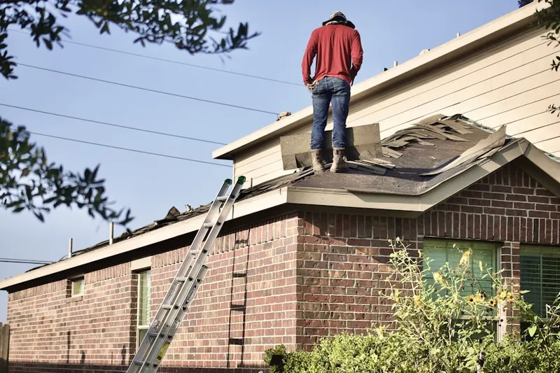 Professional roofer working on a residential roof in Eastlake